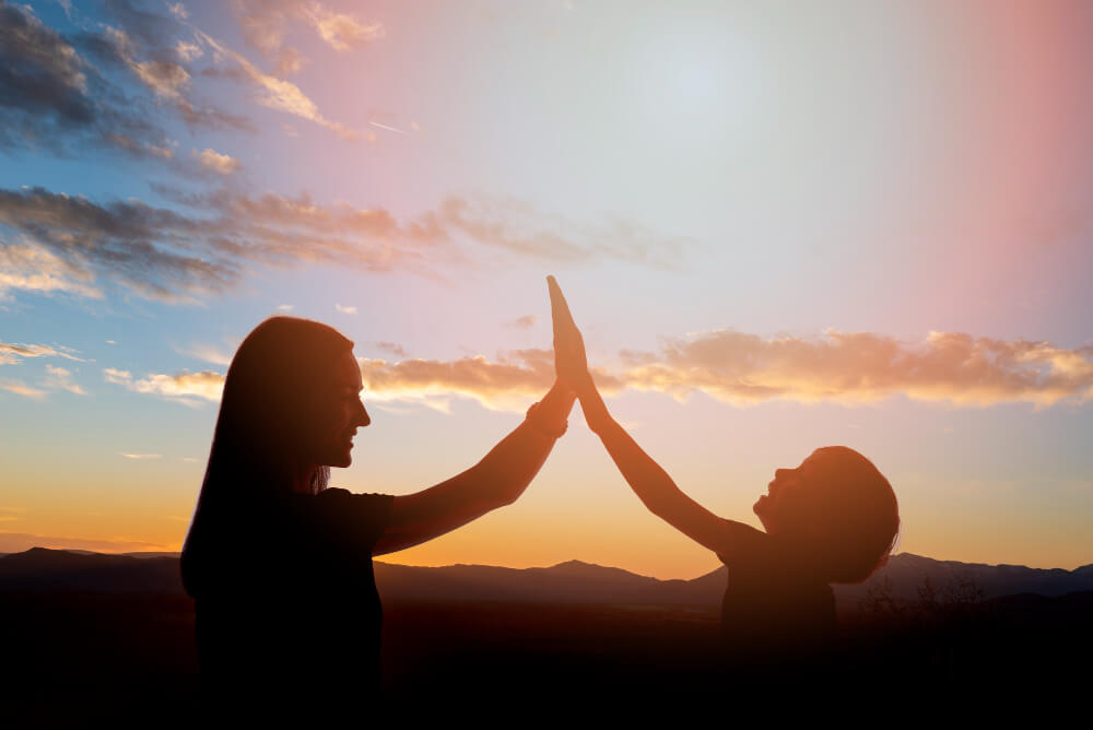 Captivating moment as the hands of a woman and a child touch, symbolizing the miracle of the confluence and connection and love.






